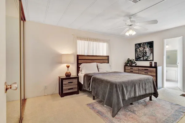 a living room with furniture and a ceiling fan