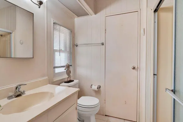 a bedroom with a bed and a ceiling fan