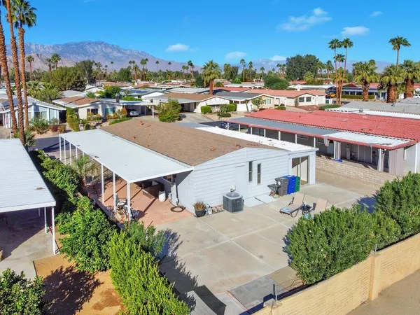 an aerial view of a house with a yard basket ball court and outdoor seating