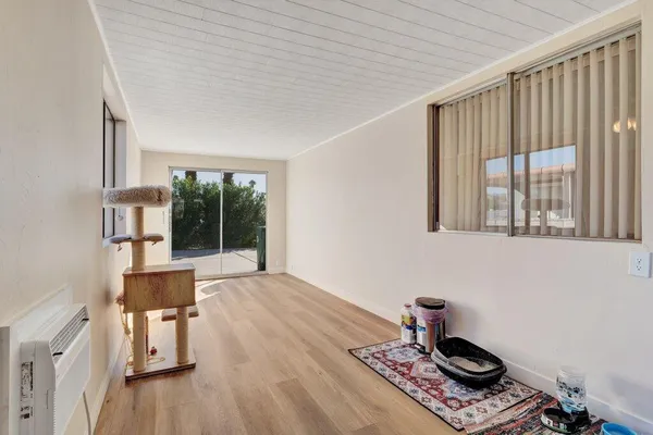 a view of a living room hardwood floor and a window