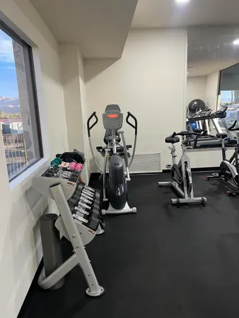 a room with gym equipment and a flat screen tv