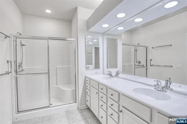 a bathroom with double vanity sink and a mirror