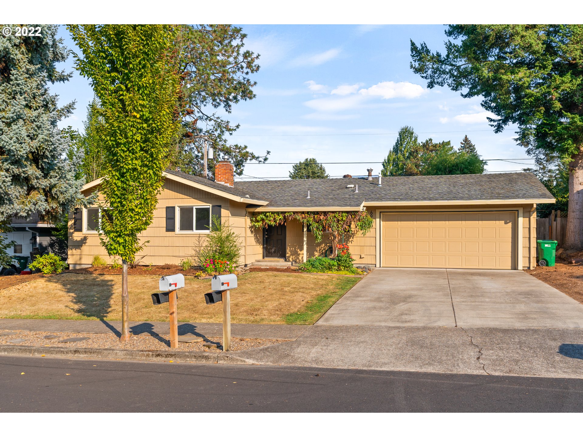 a view of house with backyard and seating space