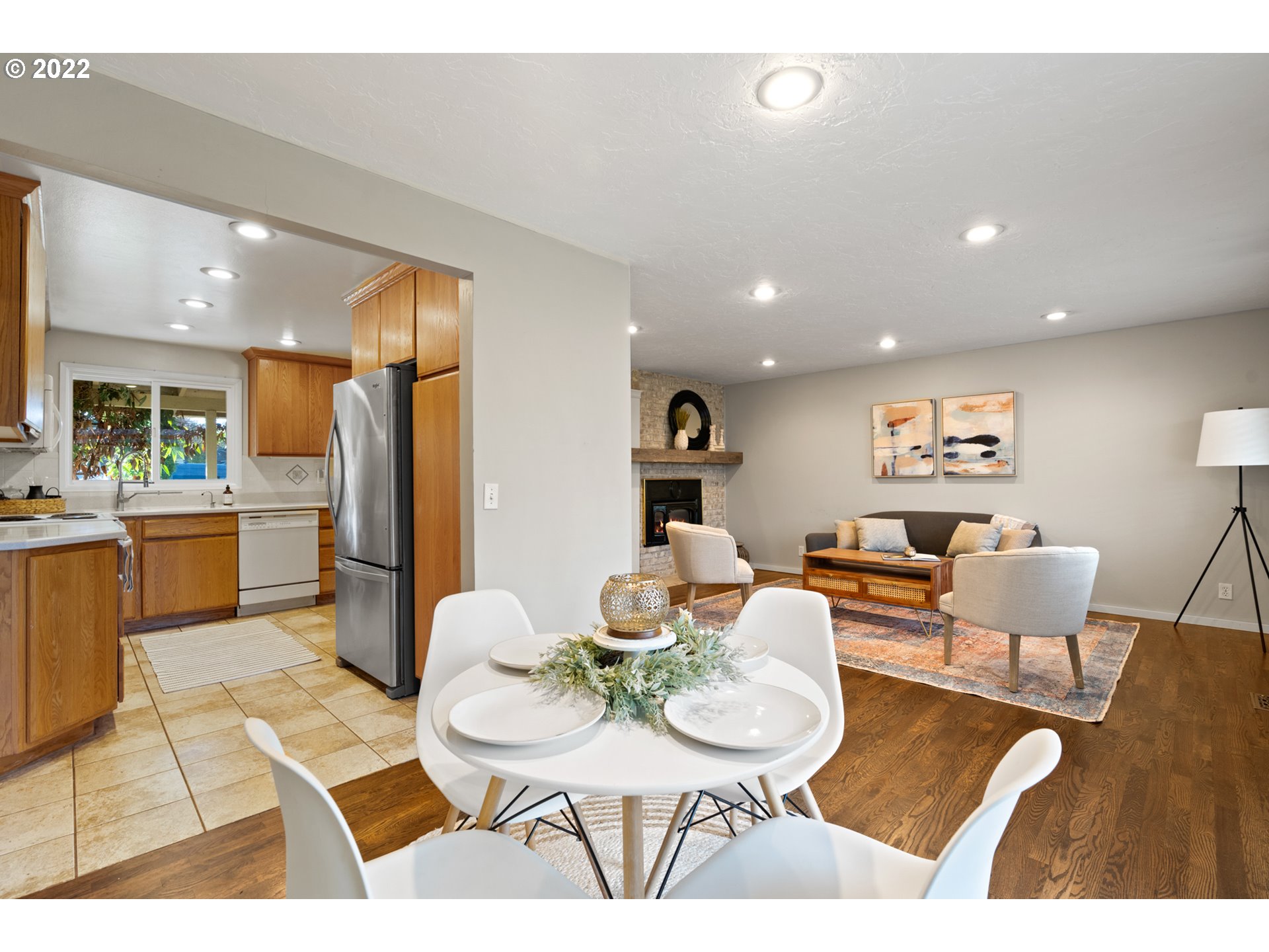 6920 Southwest Briarcliff Circle Beaverton, OR 97008 - Photo 11 of 32 a living room with furniture a refrigerator and dining table