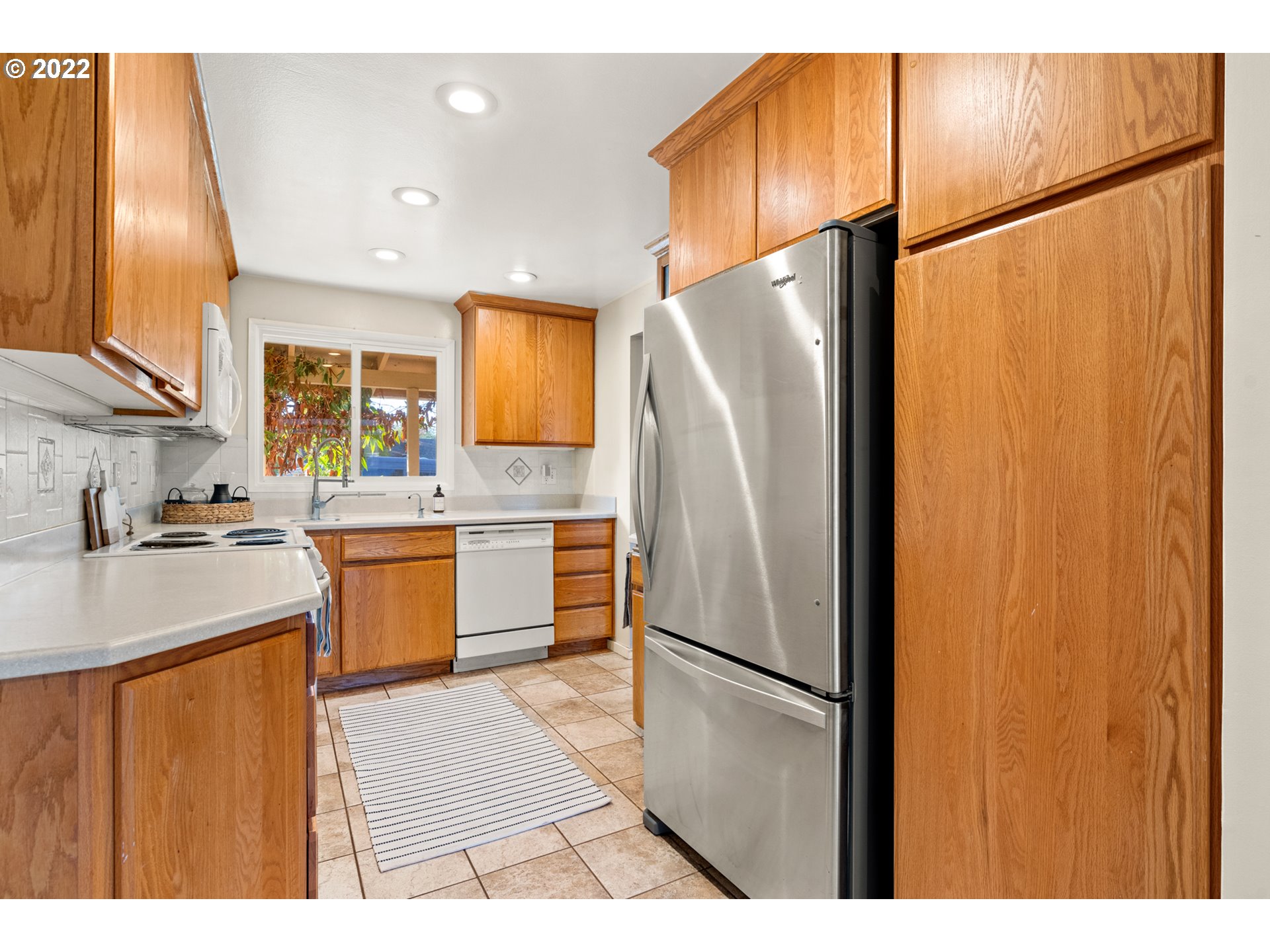 6920 Southwest Briarcliff Circle Beaverton, OR 97008 - Photo 15 of 32 a kitchen with stainless steel appliances a refrigerator and a sink