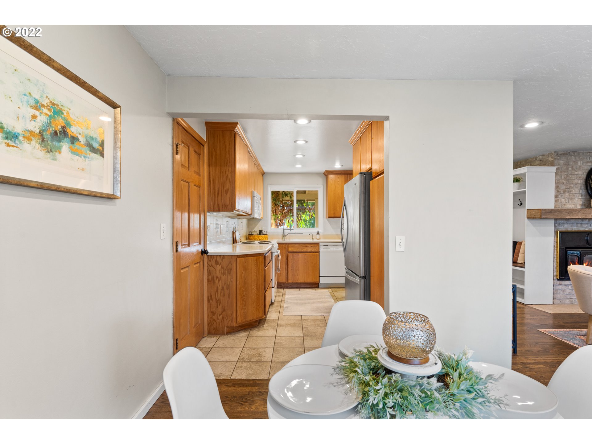 6920 Southwest Briarcliff Circle Beaverton, OR 97008 - Photo 16 of 32 a kitchen with stainless steel appliances a dining table and chairs