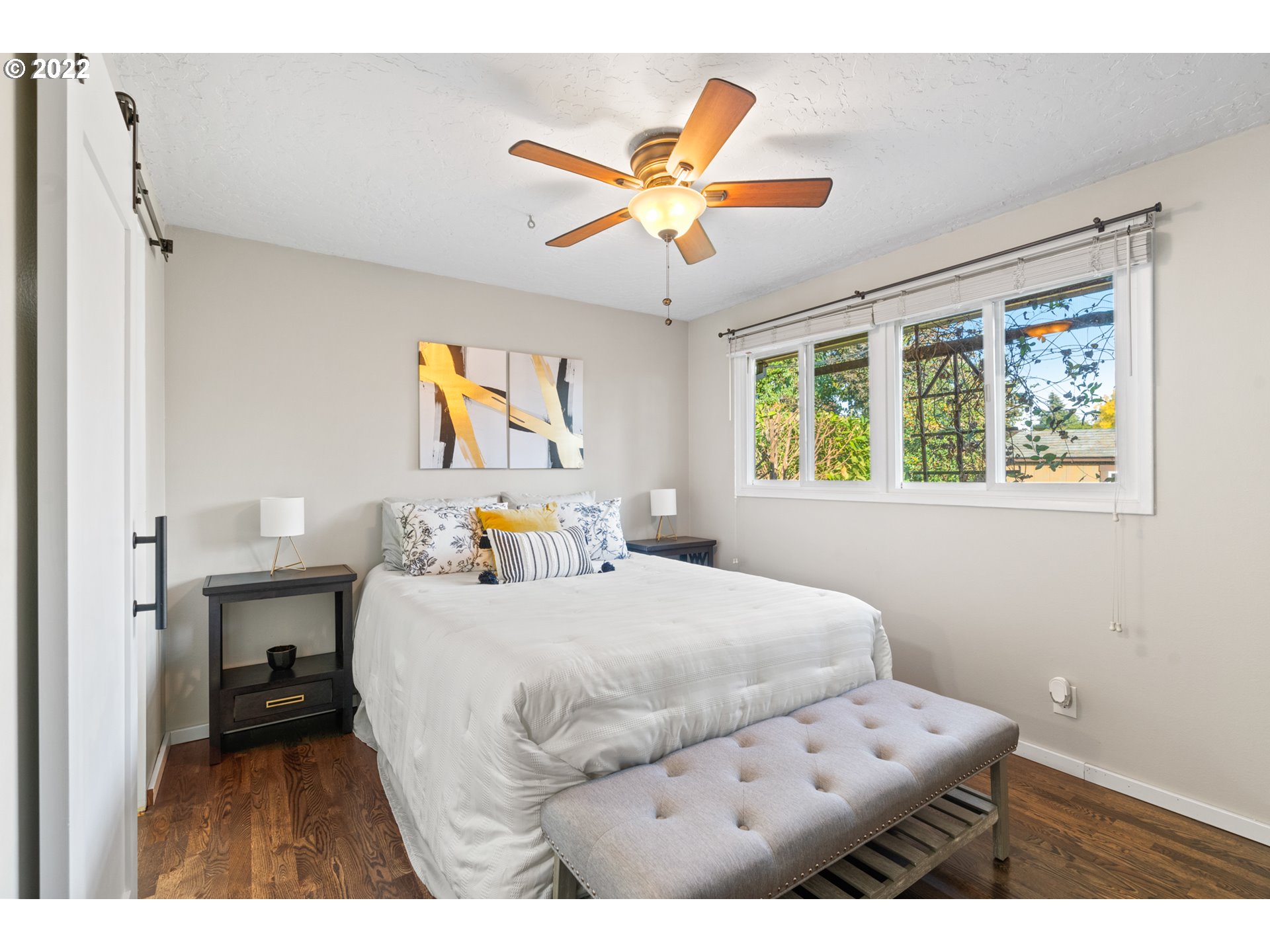 6920 Southwest Briarcliff Circle Beaverton, OR 97008 - Photo 23 of 32 a bedroom with a bed and a chandelier