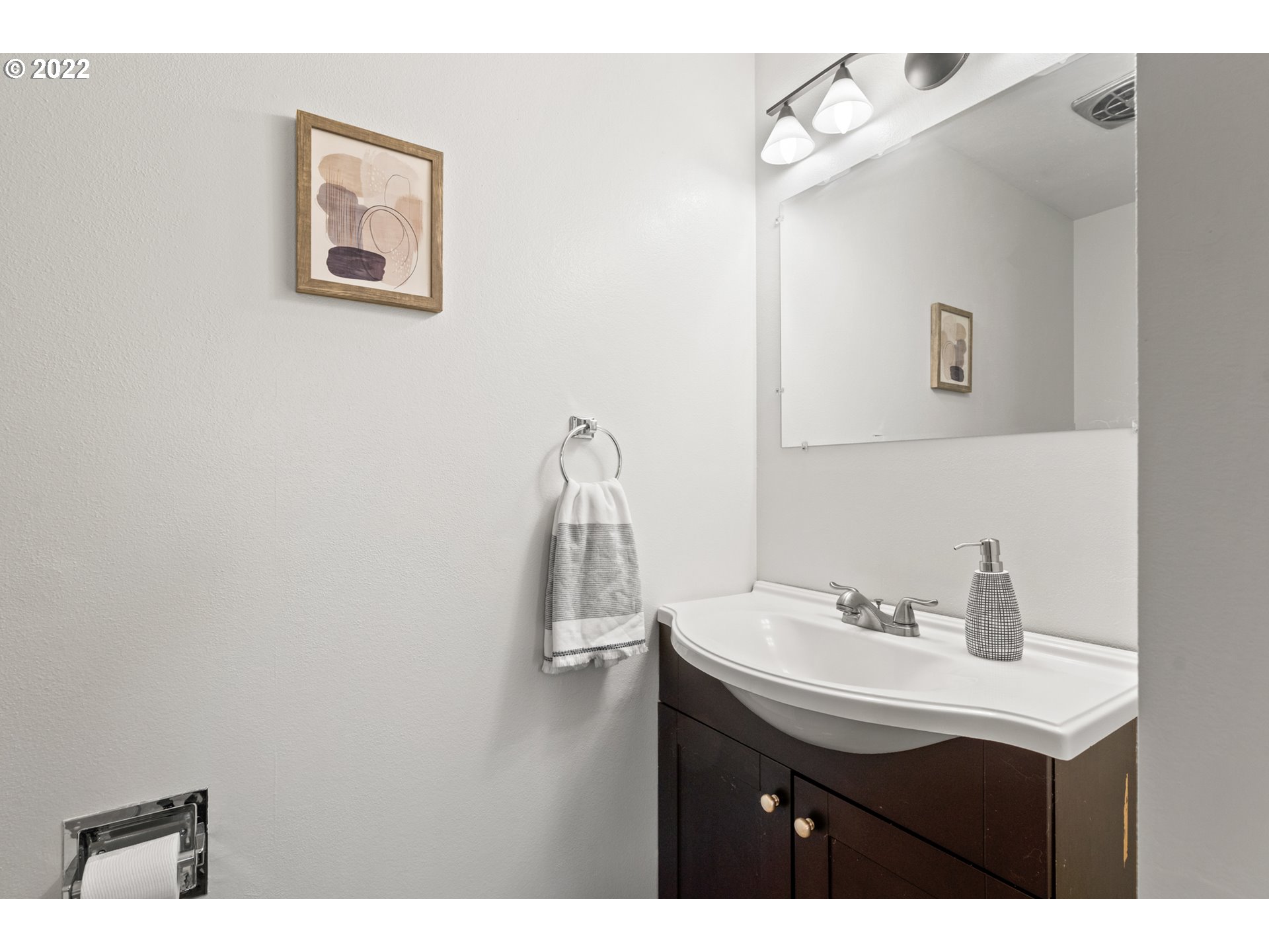 6920 Southwest Briarcliff Circle Beaverton, OR 97008 - Photo 25 of 32 a bathroom with a sink vanity and a mirror