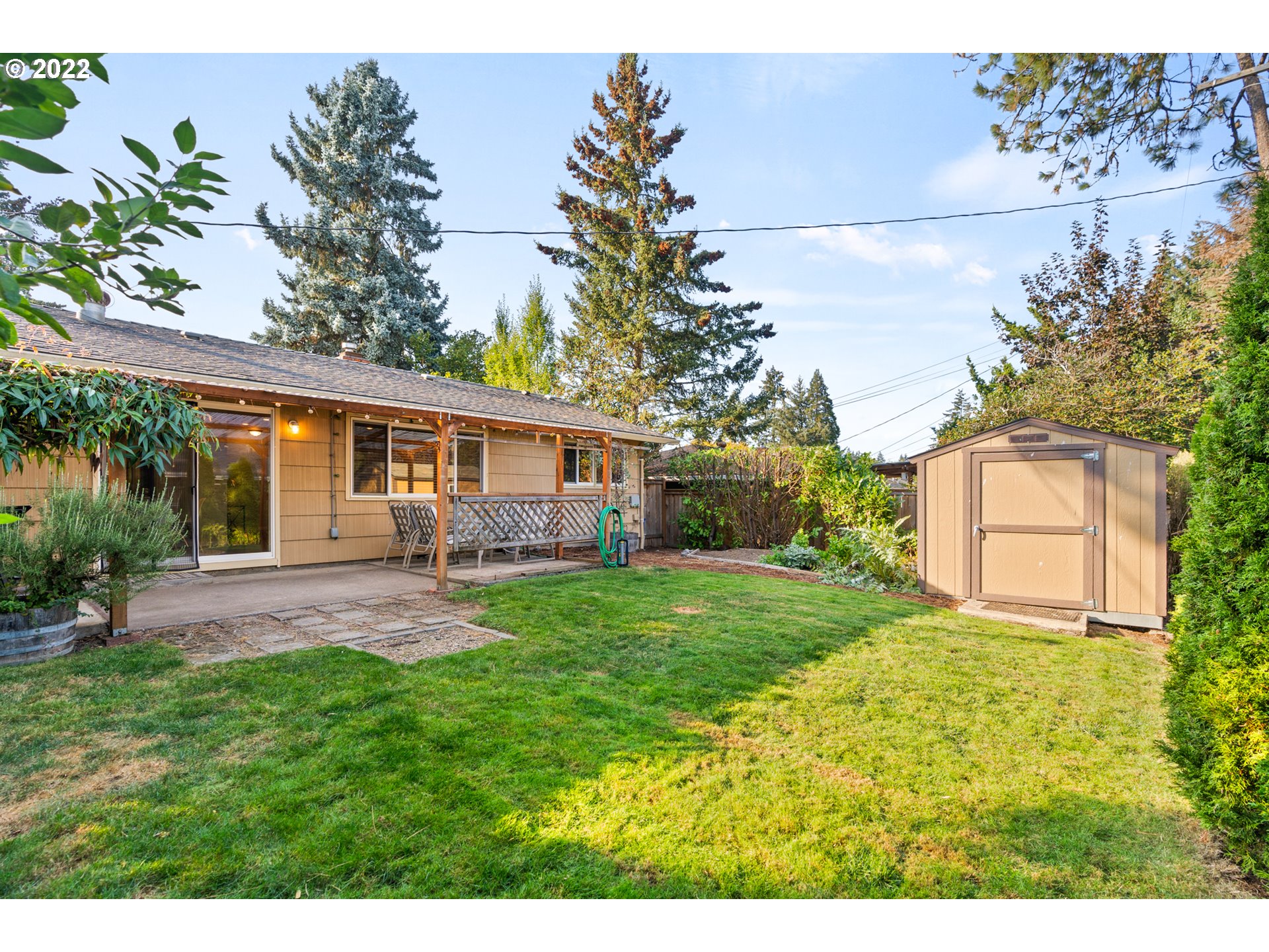 6920 Southwest Briarcliff Circle Beaverton, OR 97008 - Photo 29 of 32 a view of a house with a yard and a garden