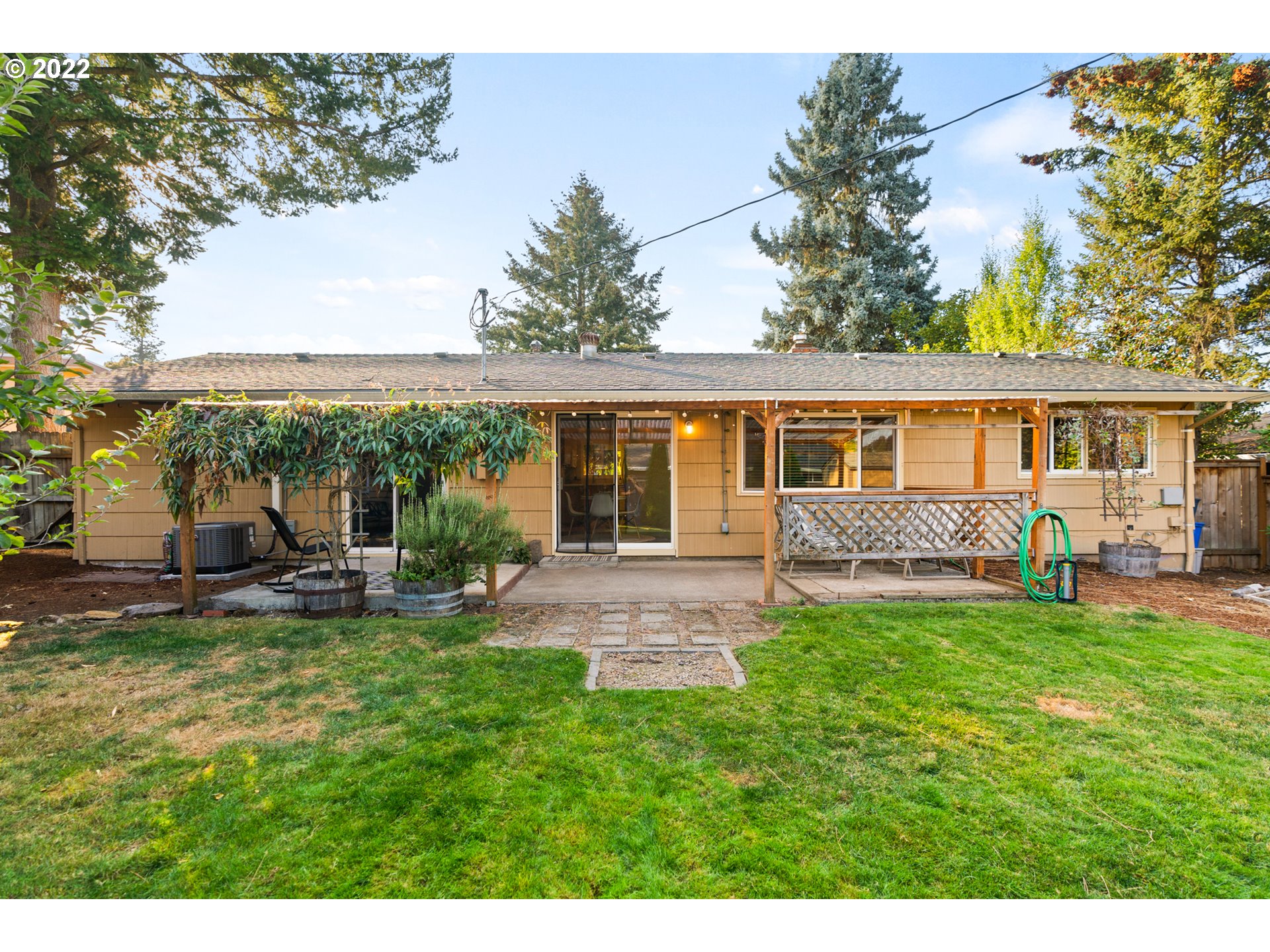 6920 Southwest Briarcliff Circle Beaverton, OR 97008 - Photo 30 of 32 a view of a house with a yard porch and sitting area