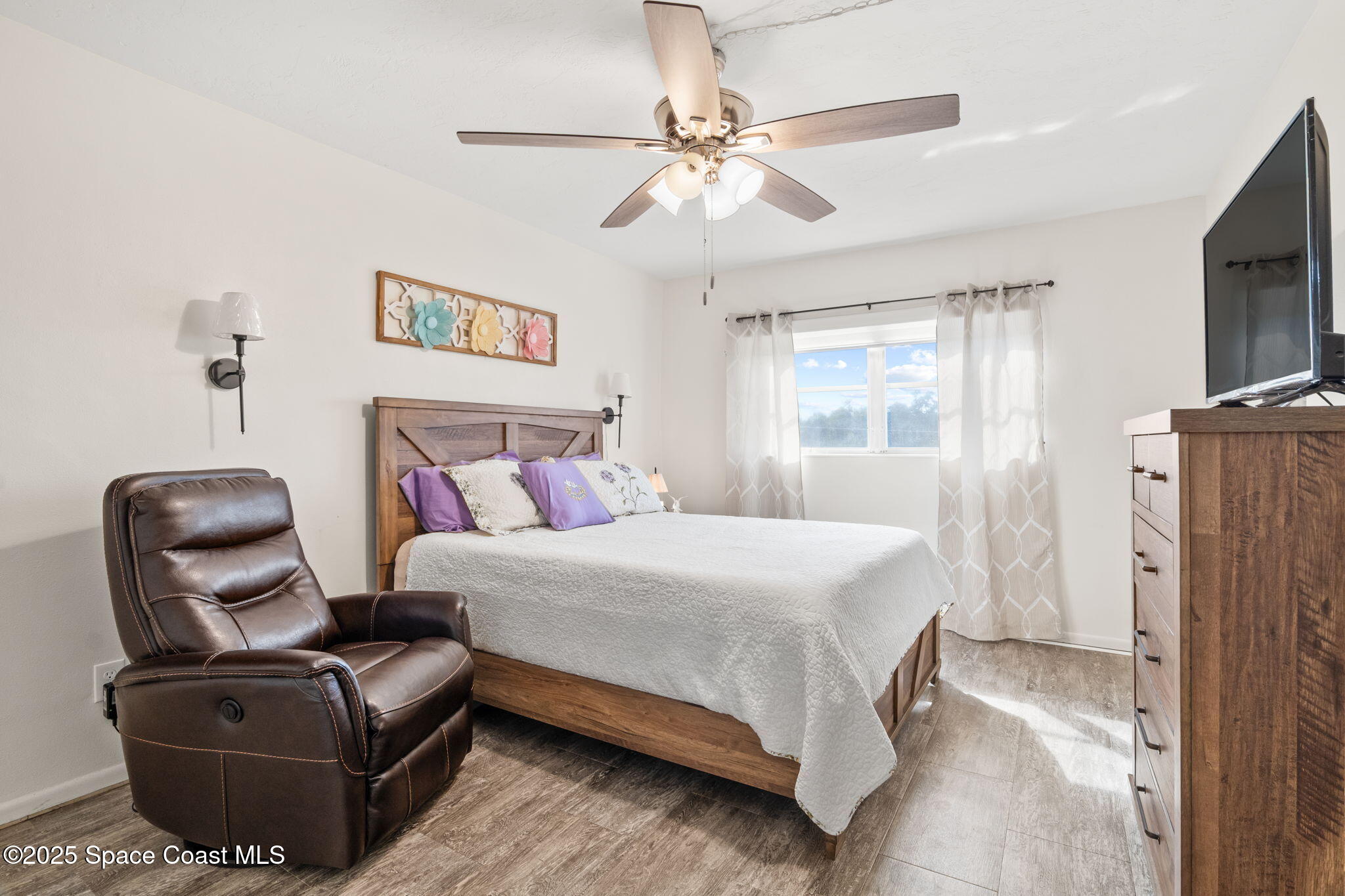 221 Columbia Drive, Unit 343 Cape Canaveral, FL 32920 - Photo 15 of 22 a bedroom with a bed couch and a window