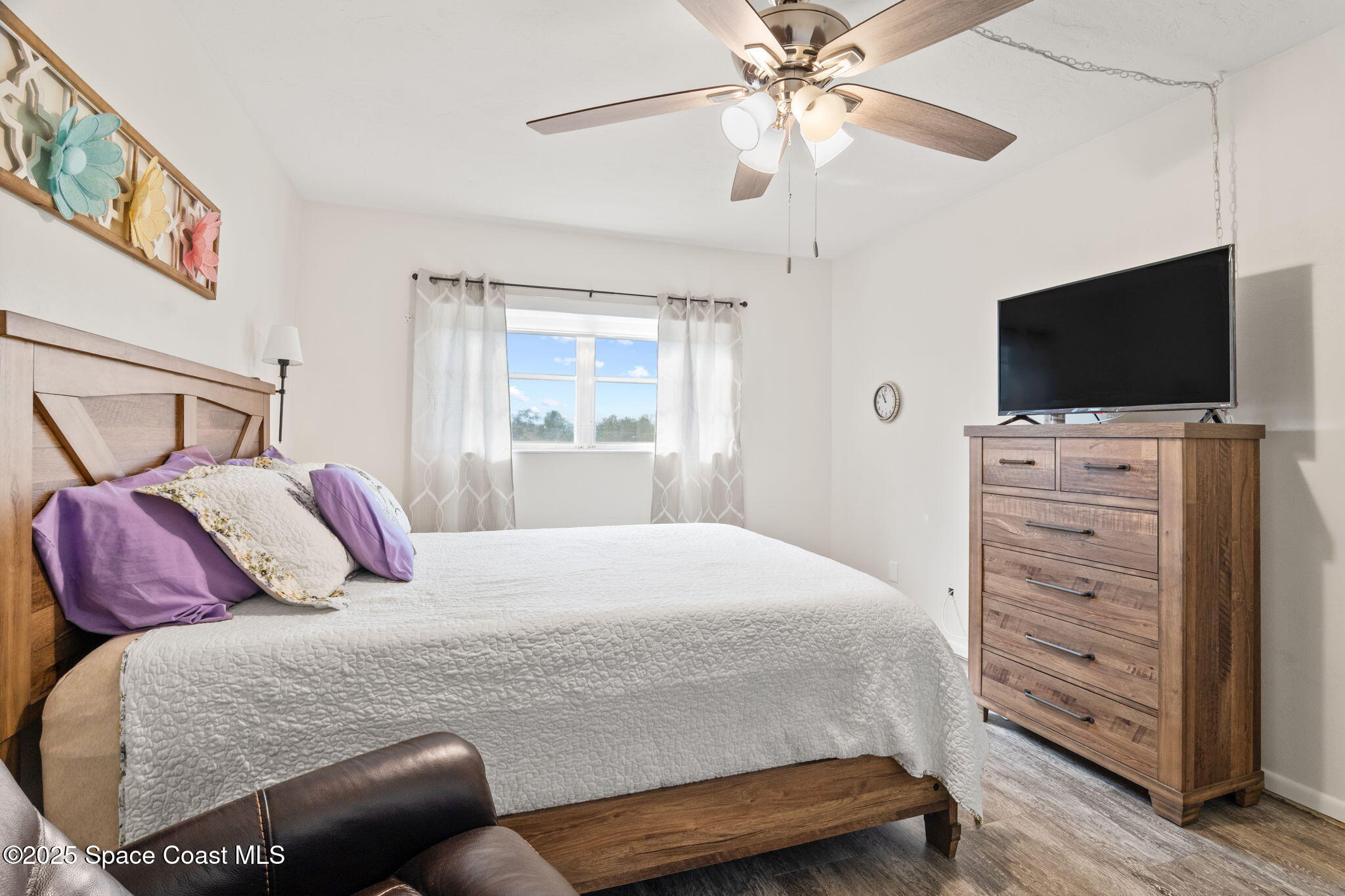 221 Columbia Drive, Unit 343 Cape Canaveral, FL 32920 - Photo 16 of 22 a bedroom with a bed and a flat screen tv