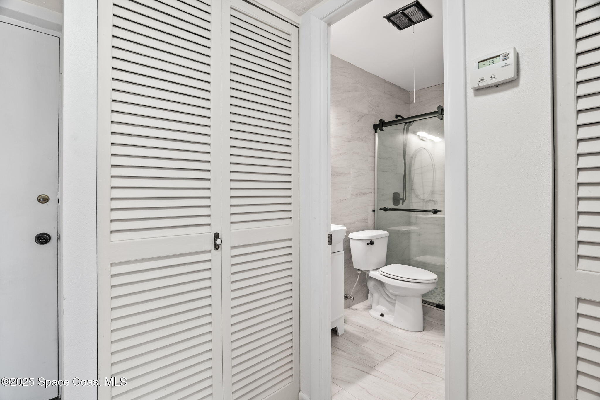 221 Columbia Drive, Unit 343 Cape Canaveral, FL 32920 - Photo 18 of 22 a bathroom with a toilet a sink and shower