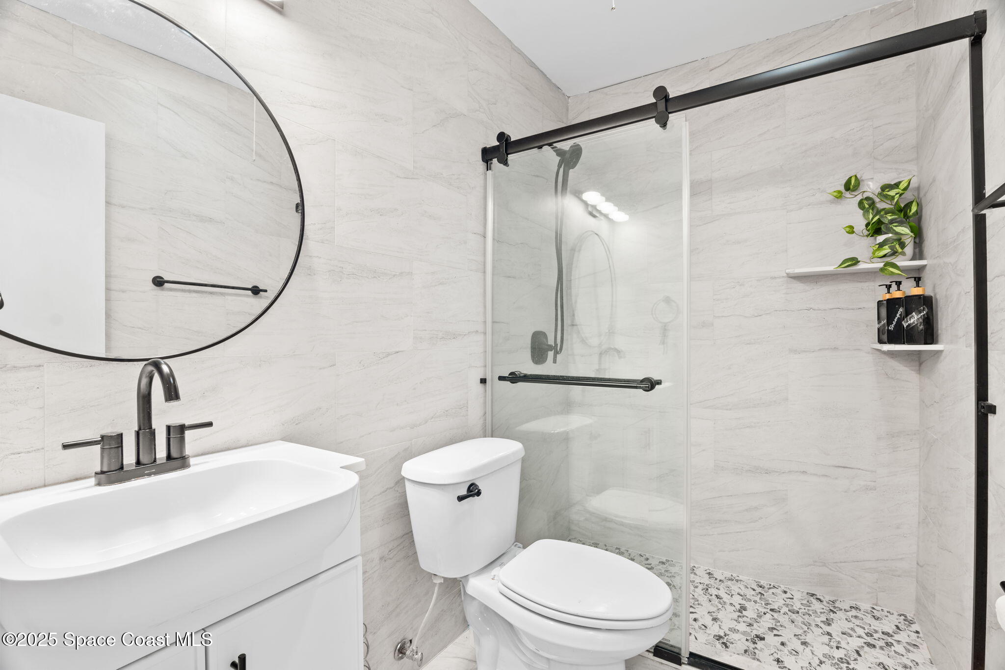 221 Columbia Drive, Unit 343 Cape Canaveral, FL 32920 - Photo 19 of 22 a bathroom with a sink a toilet and shower