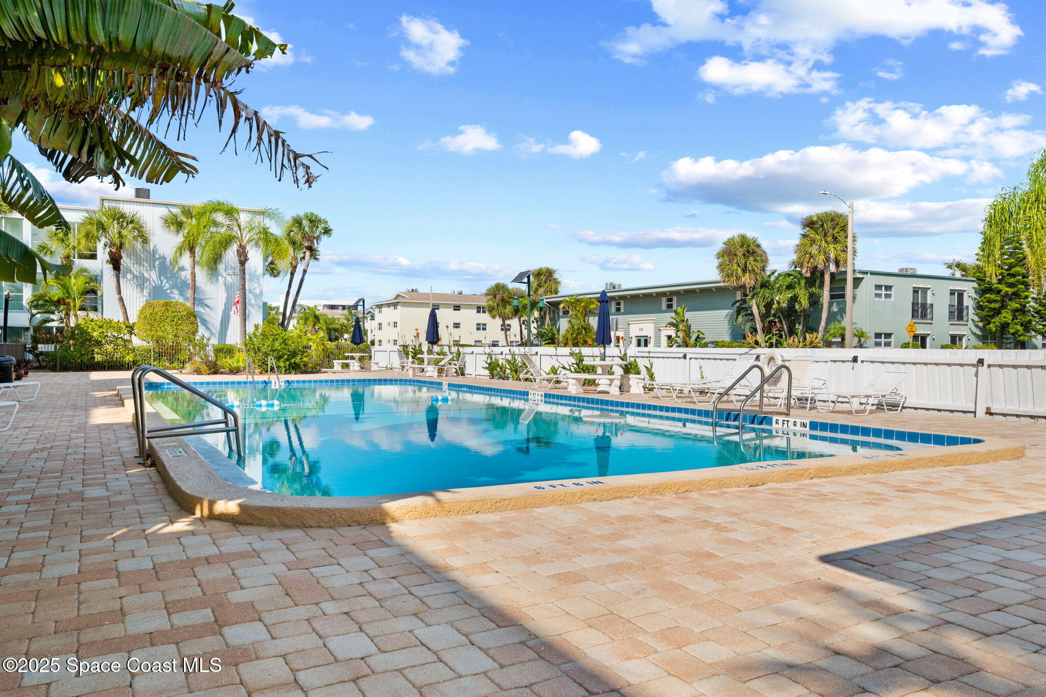 221 Columbia Drive, Unit 343 Cape Canaveral, FL 32920 - Photo 20 of 22 a view of a swimming pool with a lawn chairs