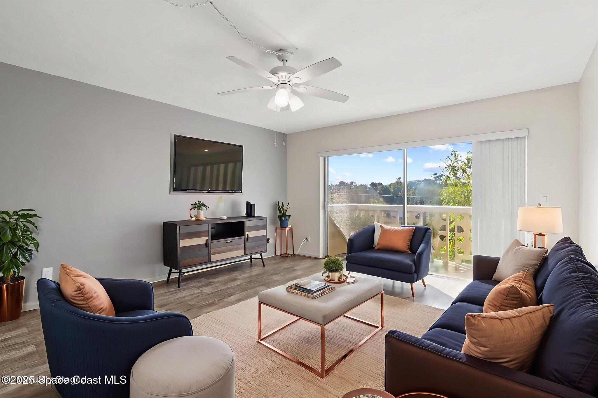 221 Columbia Drive, Unit 343 Cape Canaveral, FL 32920 - Photo 6 of 22 a living room with furniture and a flat screen tv