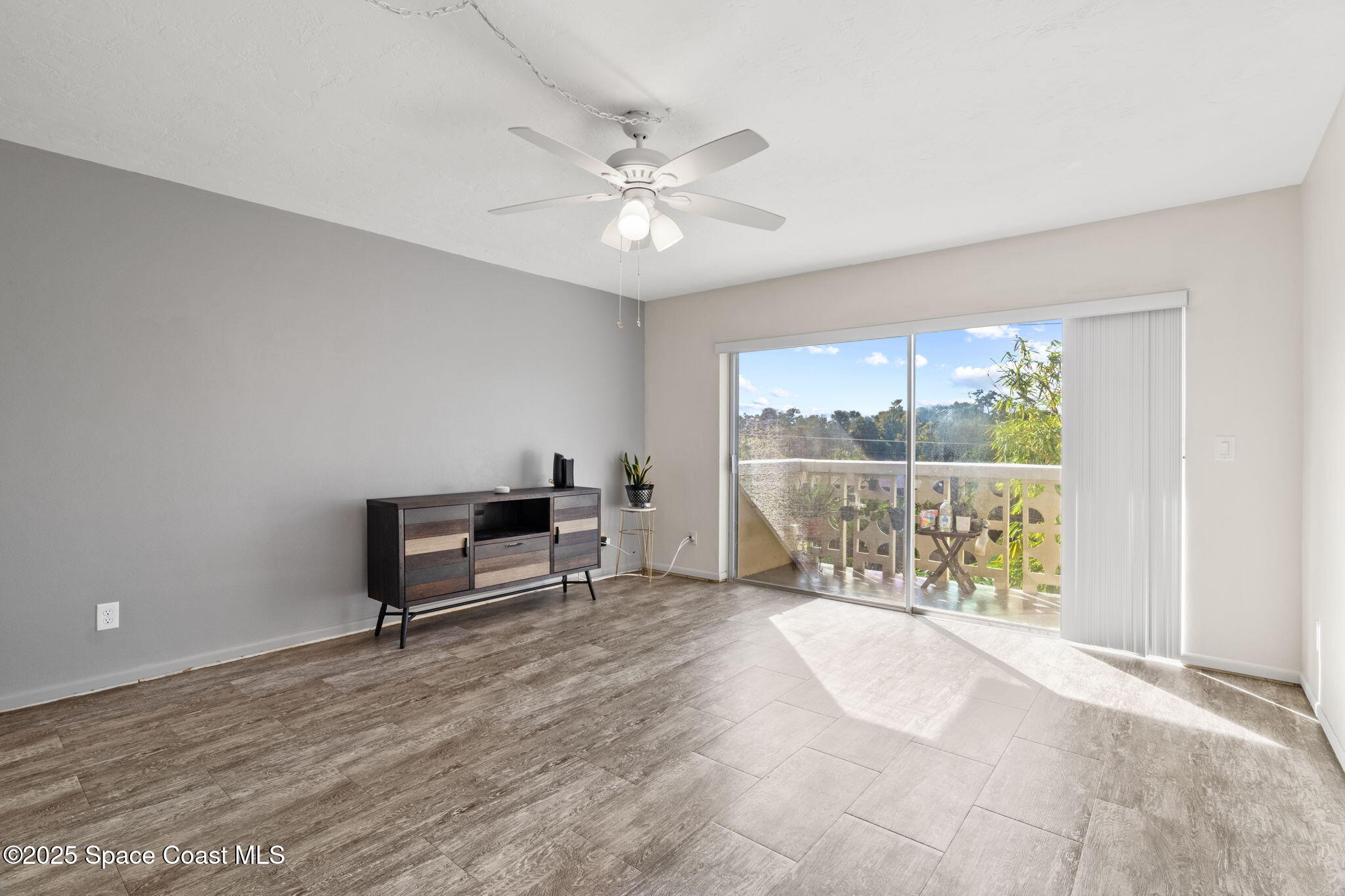 221 Columbia Drive, Unit 343 Cape Canaveral, FL 32920 - Photo 7 of 22 a view of a livingroom with a ceiling fan and a window