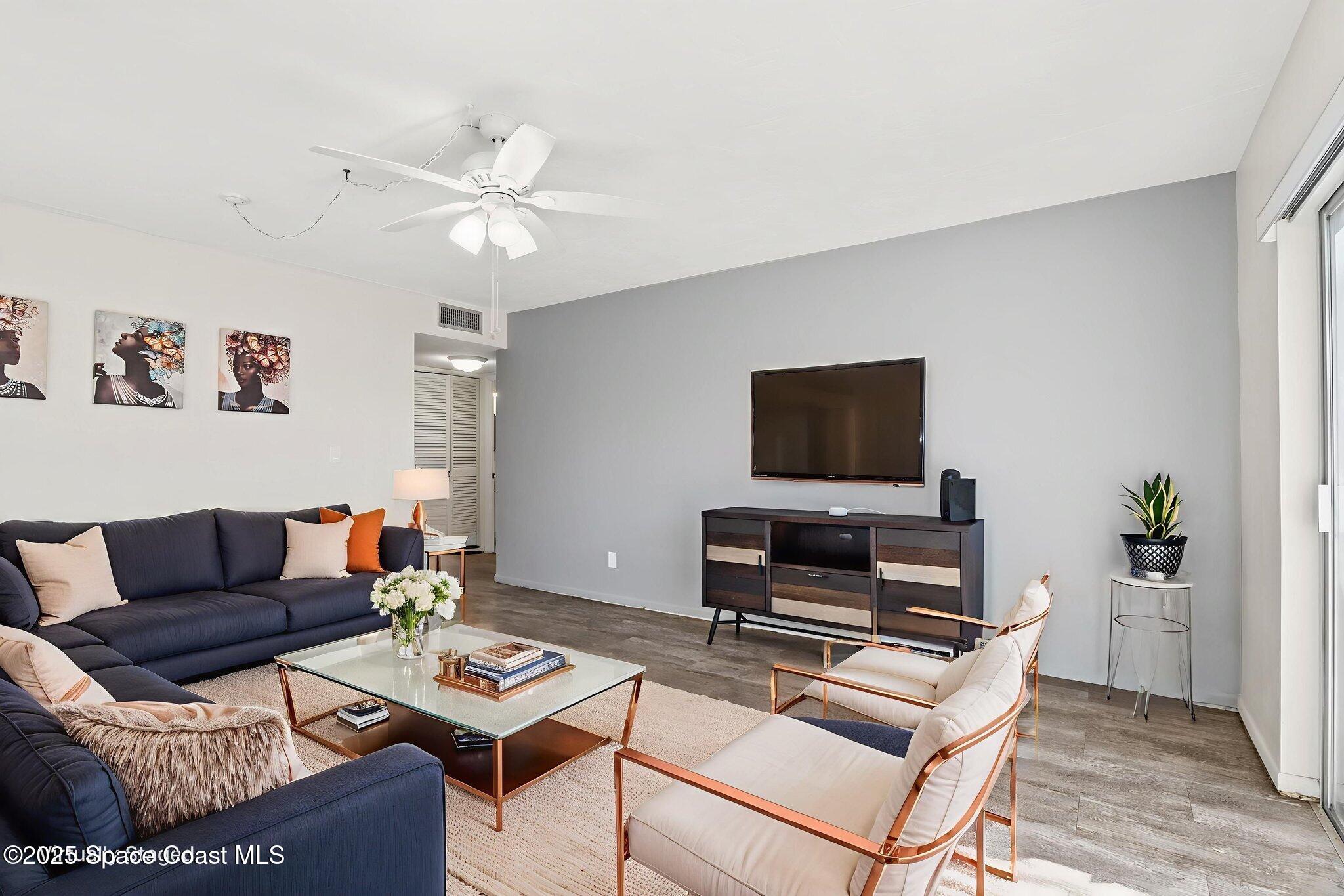 221 Columbia Drive, Unit 343 Cape Canaveral, FL 32920 - Photo 8 of 22 a living room with furniture and a flat screen tv