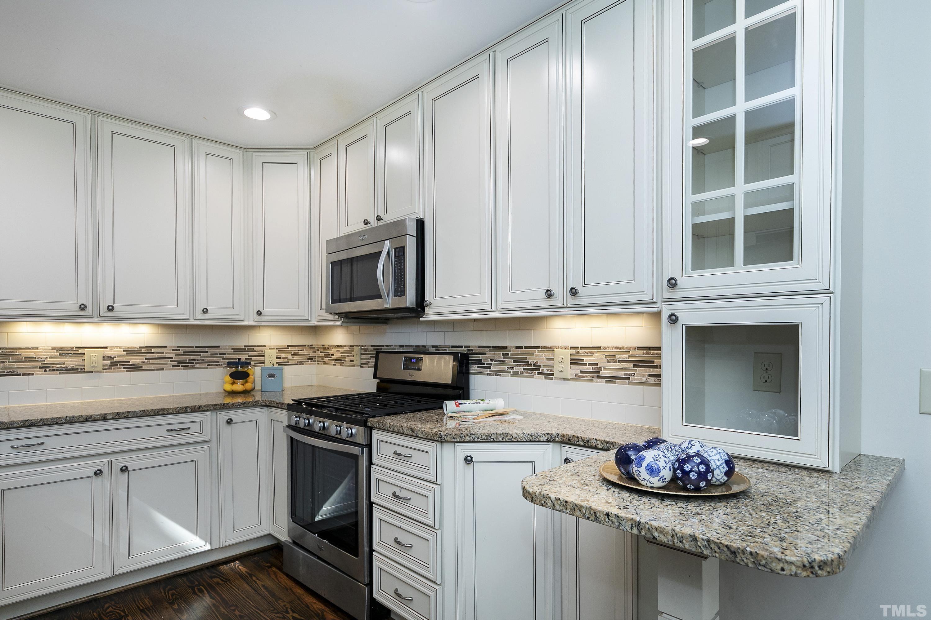 411 Dixie Trail Raleigh, NC 27607 - Photo 9 of 38 a kitchen with granite countertop a sink stove and cabinets