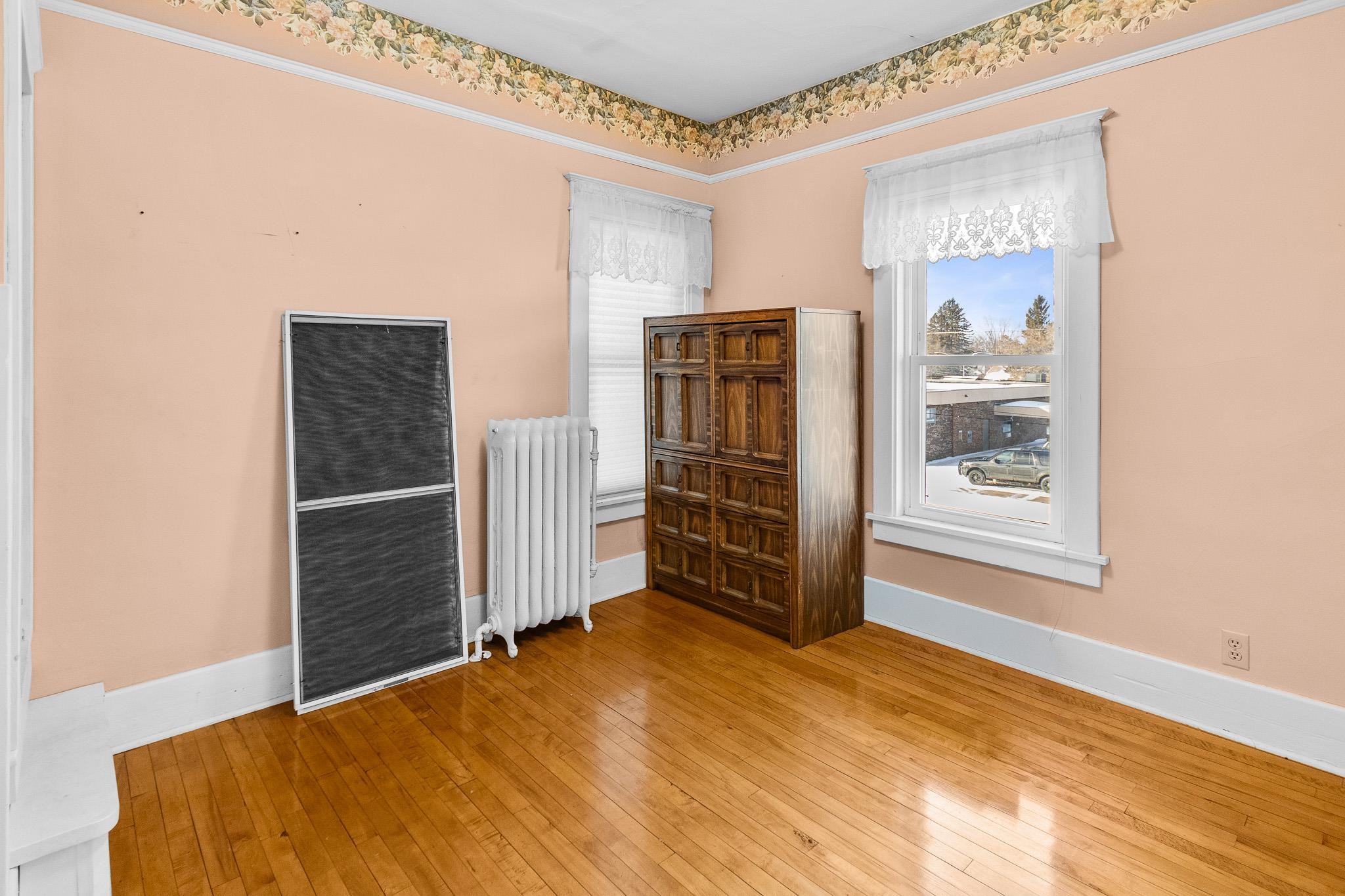 6494 School Street Finlayson, MN 55735 - Photo 11 of 32 Unfurnished room with light wood-style floors and radiator