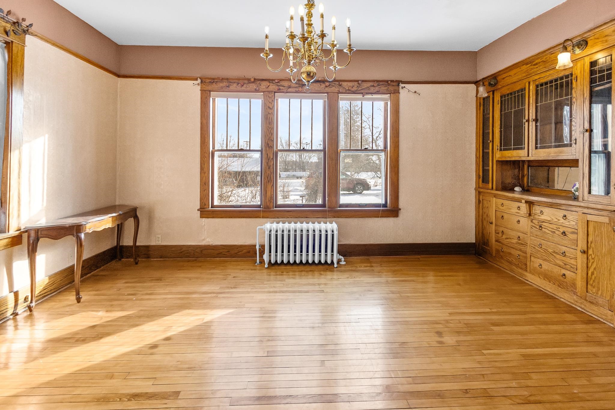6494 School Street Finlayson, MN 55735 - Photo 6 of 32 Unfurnished dining area featuring radiator, suspended lighting, and light wood-style flooring