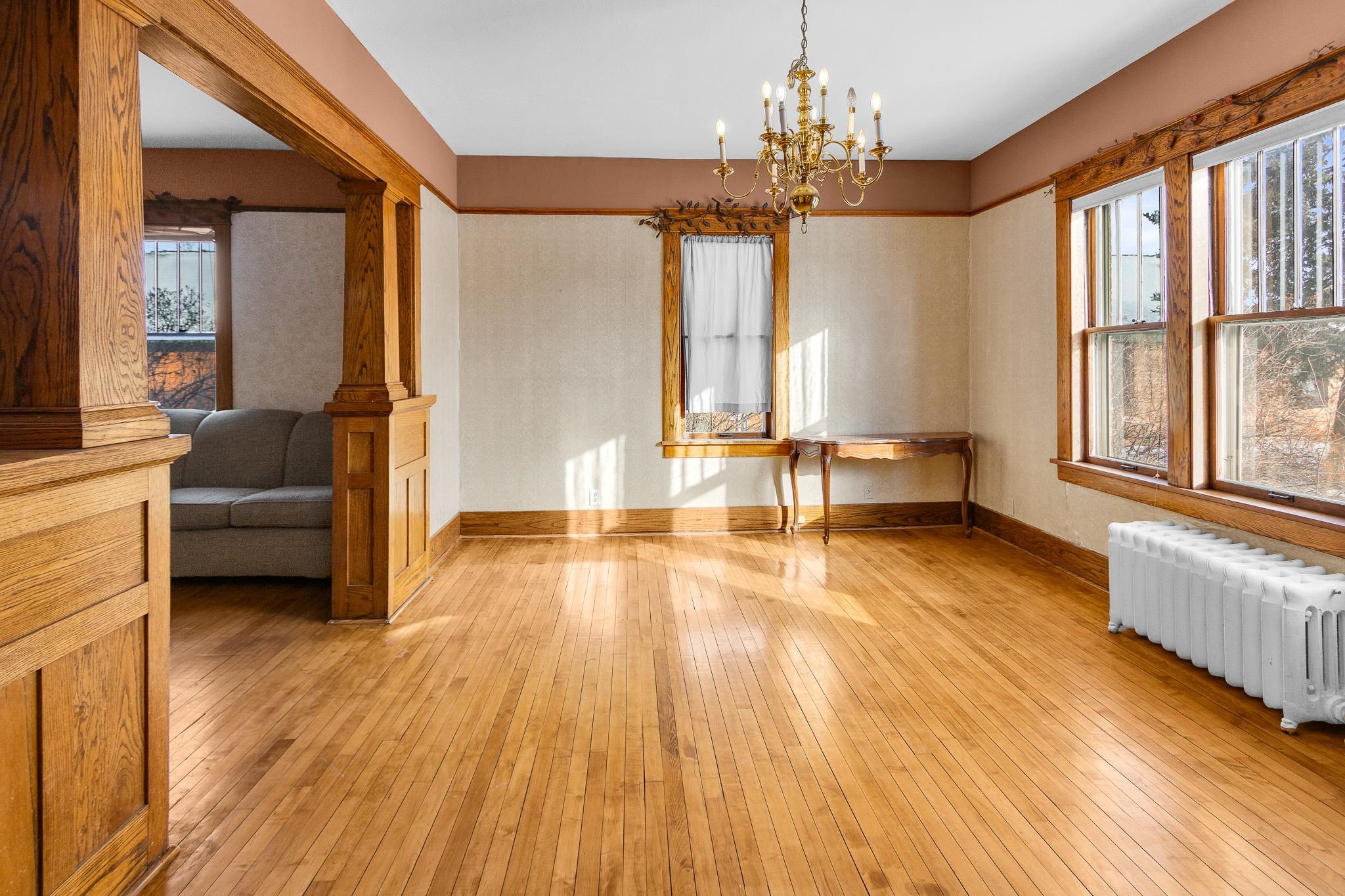6494 School Street Finlayson, MN 55735 - Photo 8 of 32 Unfurnished dining area featuring radiator, light wood-type flooring, and a chandelier