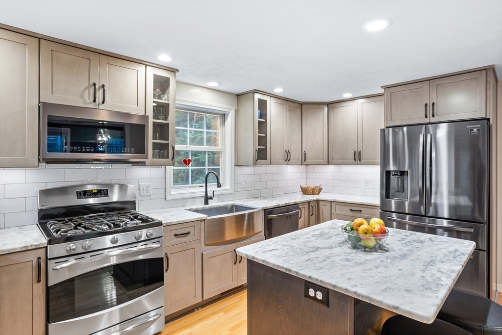 11 Little Turnpike Road Shirley, MA 01464 - Photo 6 of 36 a kitchen with stainless steel appliances granite countertop a stove top oven a sink dishwasher and a refrigerator with wooden cabinets