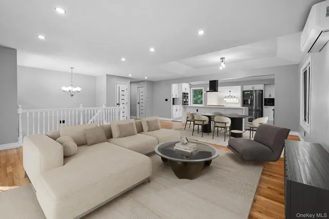 a living room with furniture a rug and kitchen view