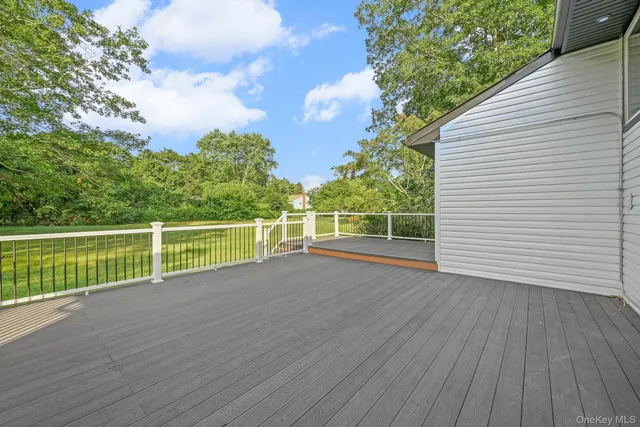 a view of a wooden deck with a yard