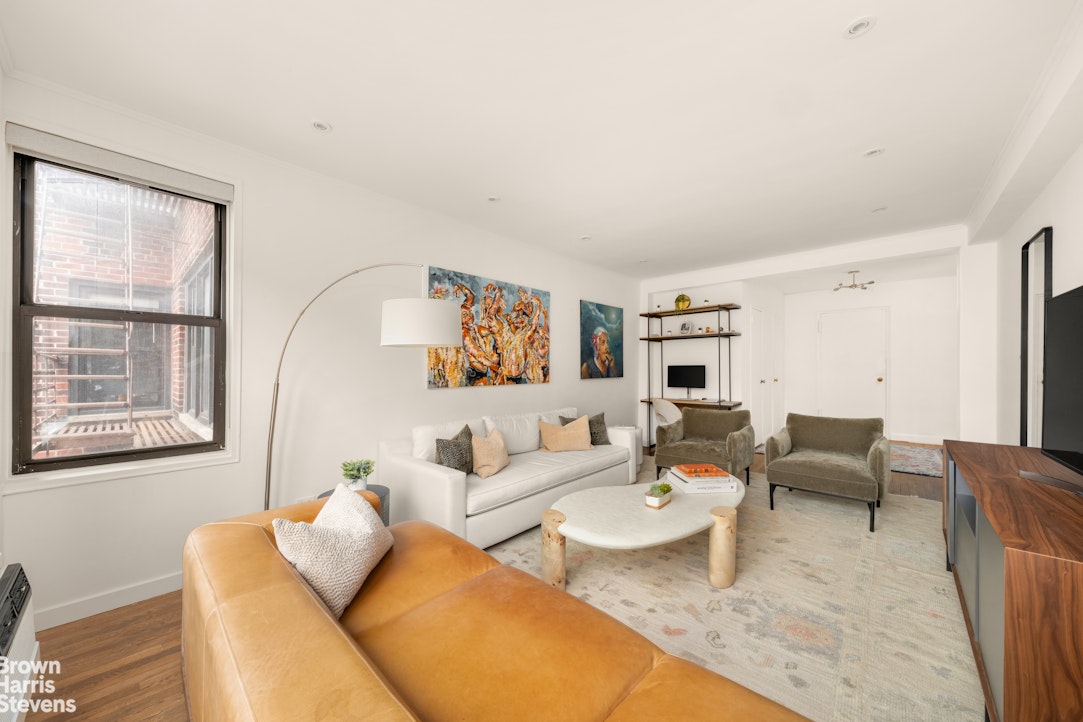 211 East 18th Street, Unit 3R Manhattan, NY 10003 - Photo 4 of 10 a living room with furniture and a large window