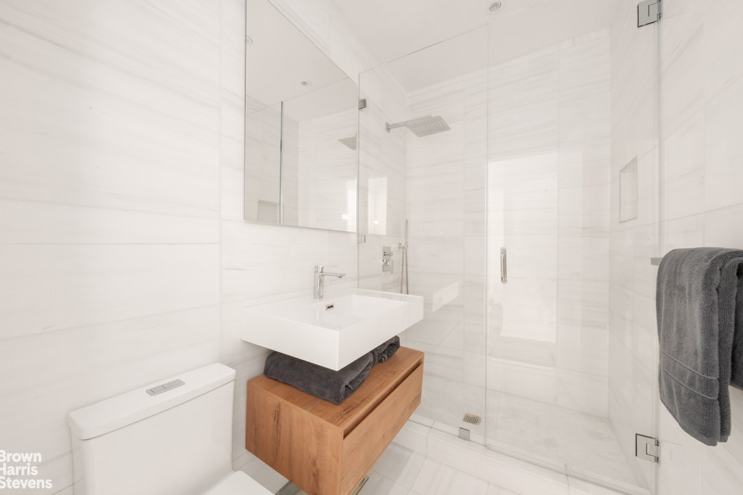 211 East 18th Street, Unit 3R Manhattan, NY 10003 - Photo 9 of 10 a bathroom with a sink a toilet and shower