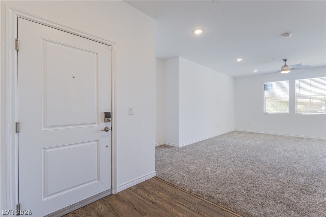 2555 Hampton Road, Unit 8206 Henderson, NV 89052 - Photo 7 of 25 A welcoming entryway with rich wood flooring transitions seamlessly into a carpeted living space.