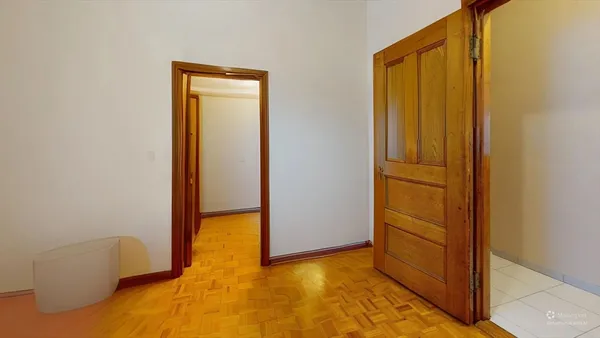 a view of an empty room and bathroom