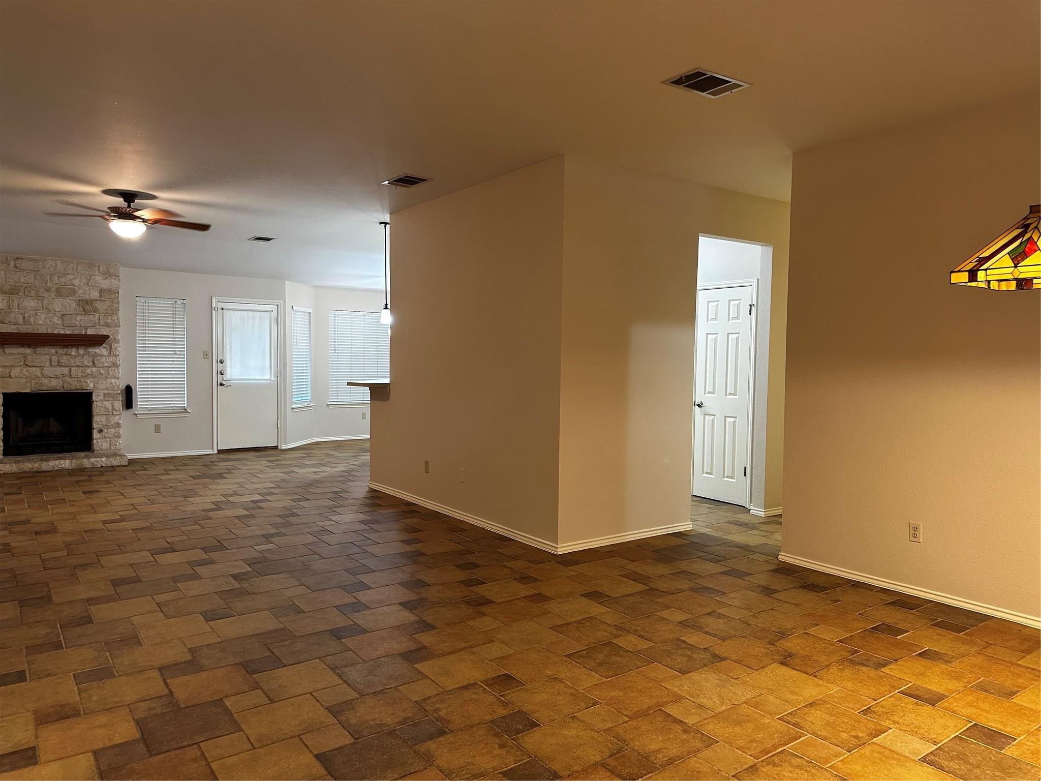 8007 Bounty Trail Austin, TX 78749 - Photo 8 of 32 A spacious living area offers a cozy fireplace and attractive tiled flooring.