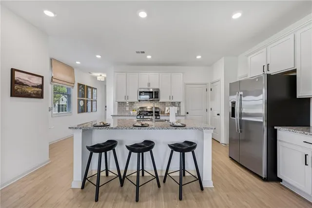 a bedroom with a bed a mirror and a table