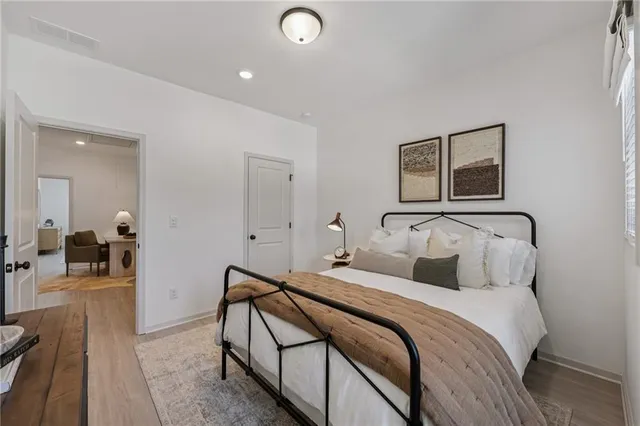 a living room with a black white checkered floor with couches chair and a dining table with a large window