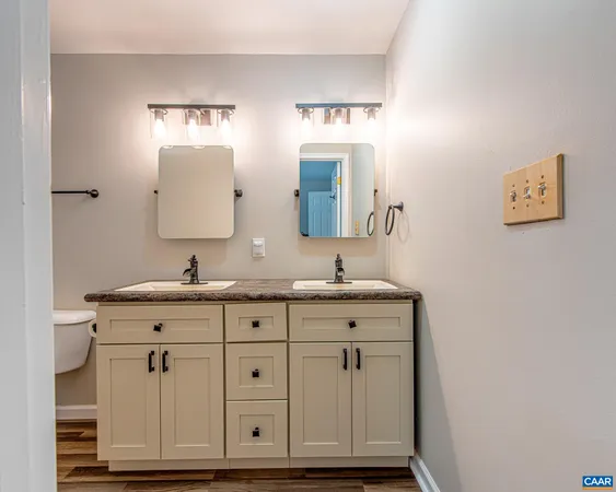 a bathroom with granite countertop white vanity a mirror and vanity