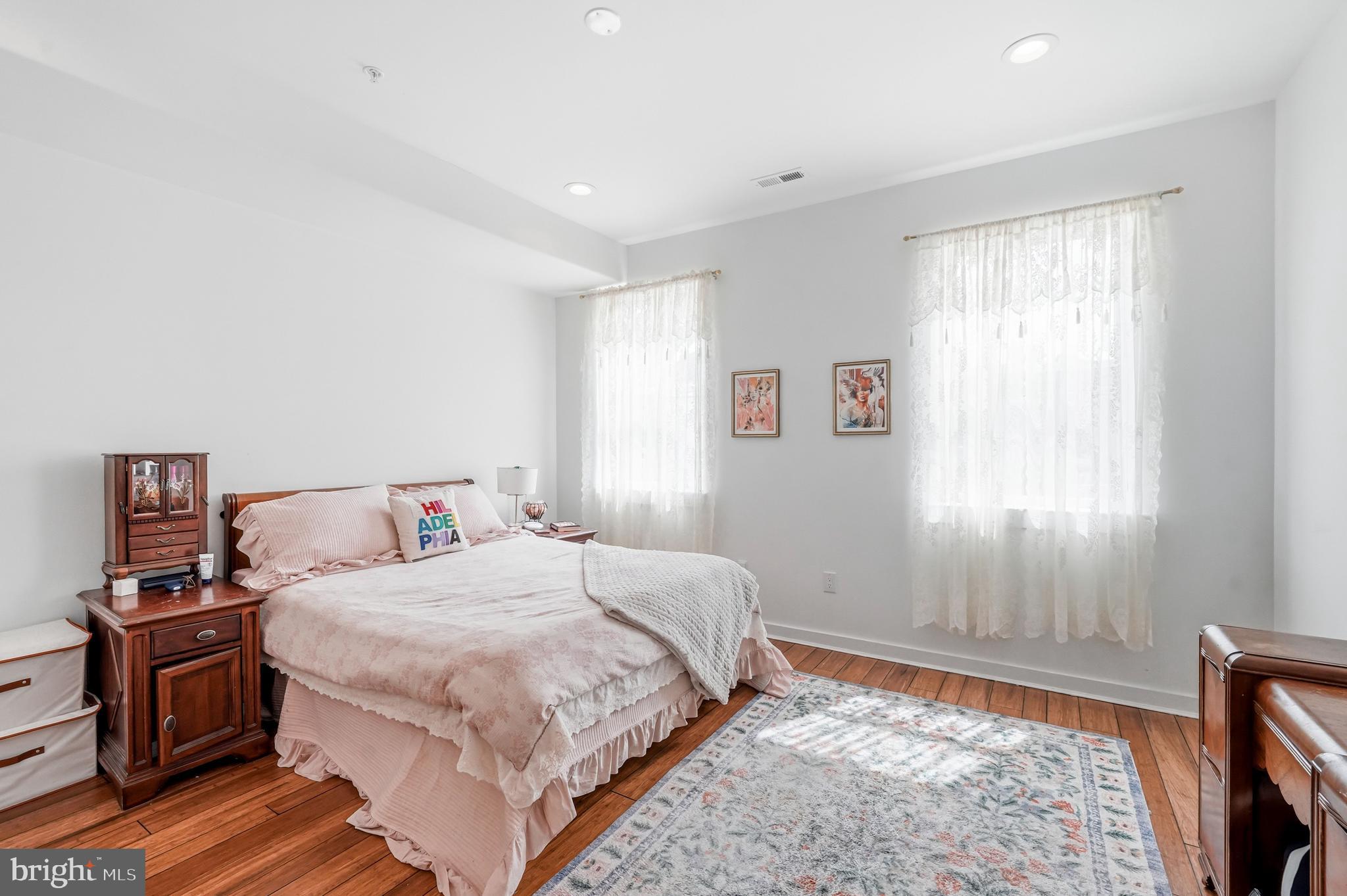2604 Reed Street Philadelphia, PA 19146 - Photo 17 of 45 a bedroom with a bed and wooden floor