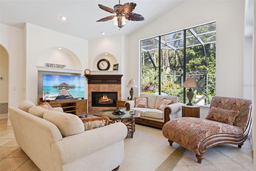 799 Oak Shadows Road Celebration, FL 34747 - Photo 11 of 97 a living room with furniture a large window and a fireplace