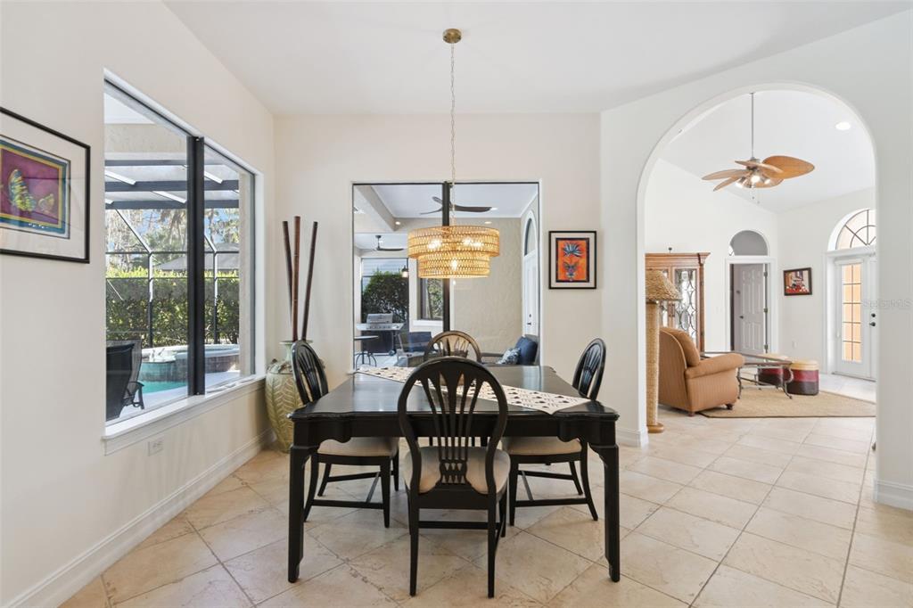 799 Oak Shadows Road Celebration, FL 34747 - Photo 14 of 97 a view of a dining room with furniture window and outside view