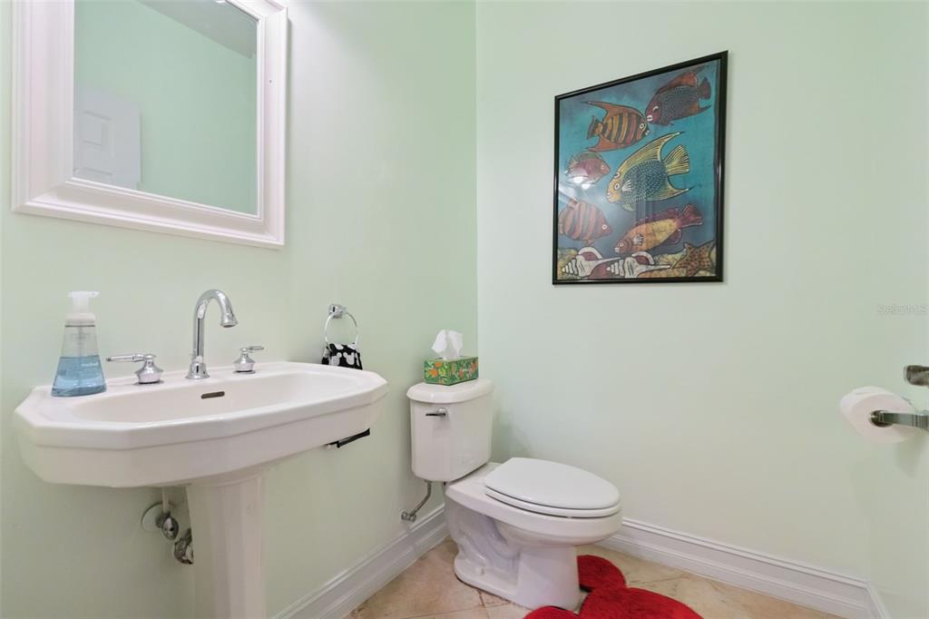 799 Oak Shadows Road Celebration, FL 34747 - Photo 19 of 97 a bathroom with a toilet a sink and mirror