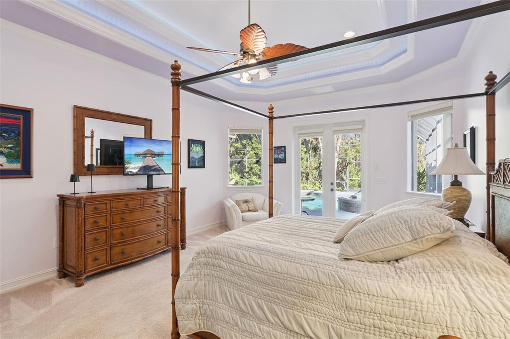 799 Oak Shadows Road Celebration, FL 34747 - Photo 20 of 97 a bedroom with a bed cabinets and flat screen tv