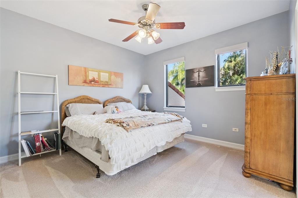 799 Oak Shadows Road Celebration, FL 34747 - Photo 34 of 97 a spacious bedroom with a bed and a window