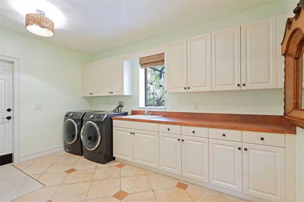 799 Oak Shadows Road Celebration, FL 34747 - Photo 40 of 97 a utility room with sink dryer and washer