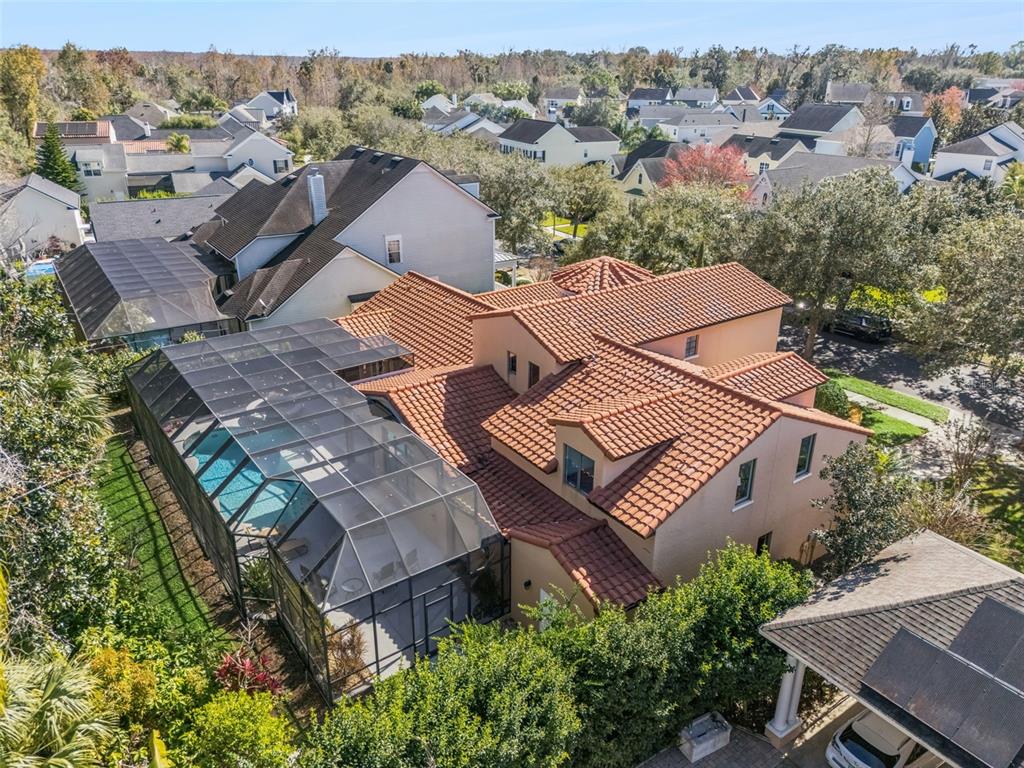 799 Oak Shadows Road Celebration, FL 34747 - Photo 57 of 97 an aerial view of a house with a yard and trees