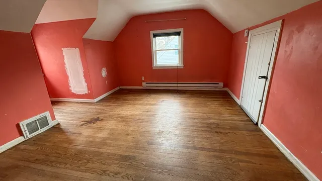 a view of a room with wooden floor and window