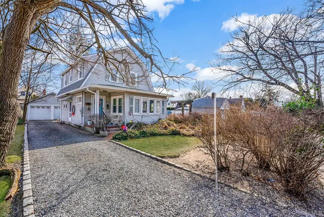 a view of a house with a yard and pathway