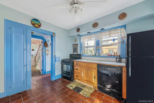 a open kitchen with stainless steel appliances granite countertop a refrigerator and a sink