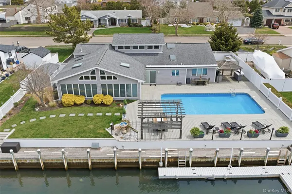 a view of house with yard swimming pool and outdoor seating