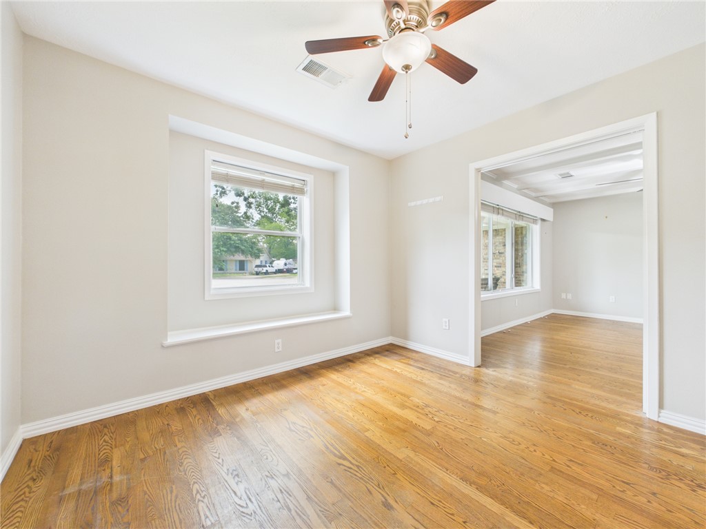 902 Briar Bend Court Bryan, TX 77802 - Photo 7 of 39 a view of an empty room with window and wooden floor